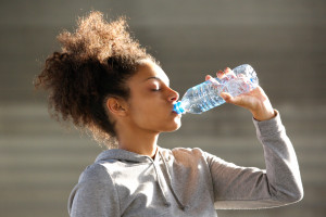 Attractive Young Woman Drinking Water From Bottle